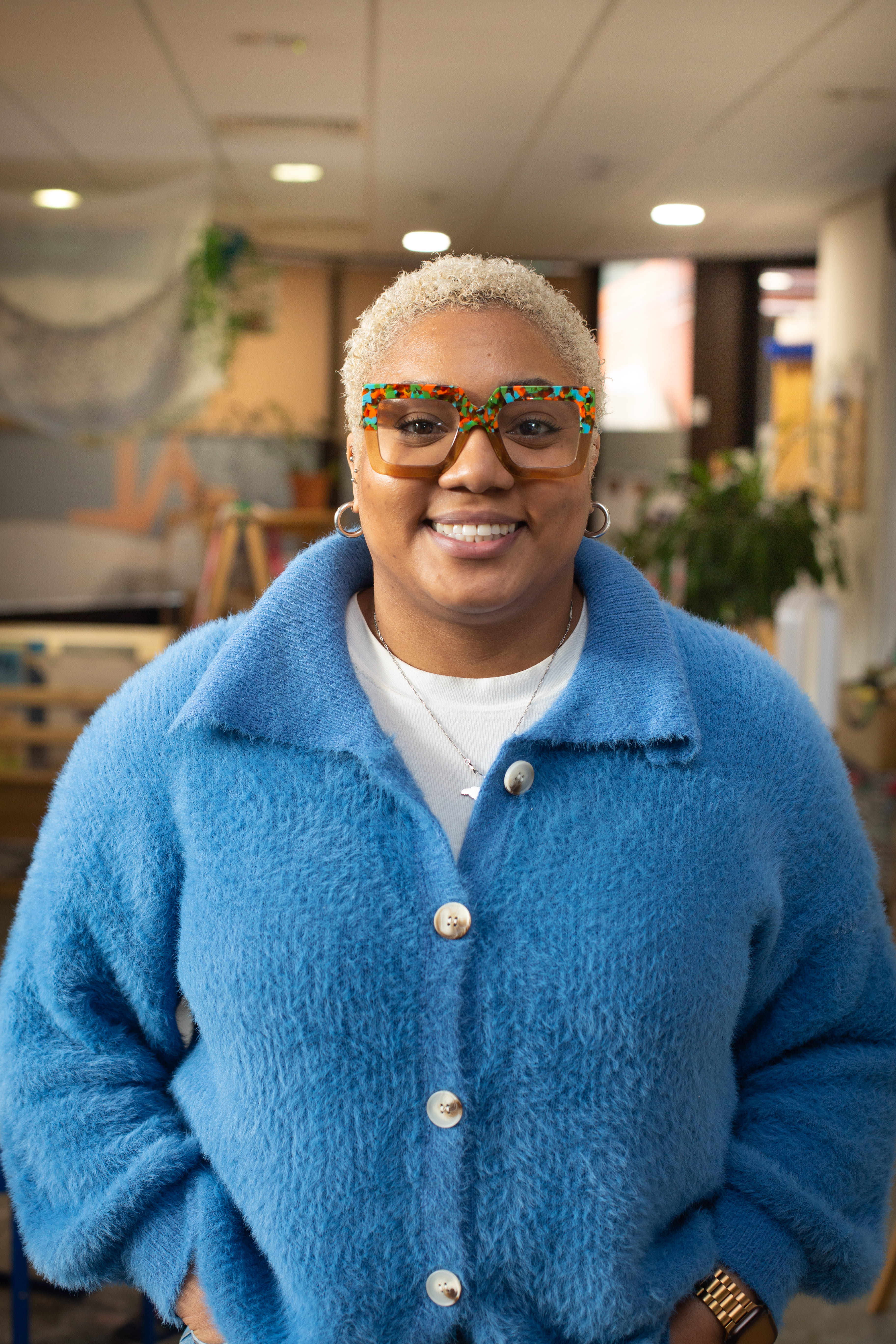 portrait of blonde lady with blue cardigan